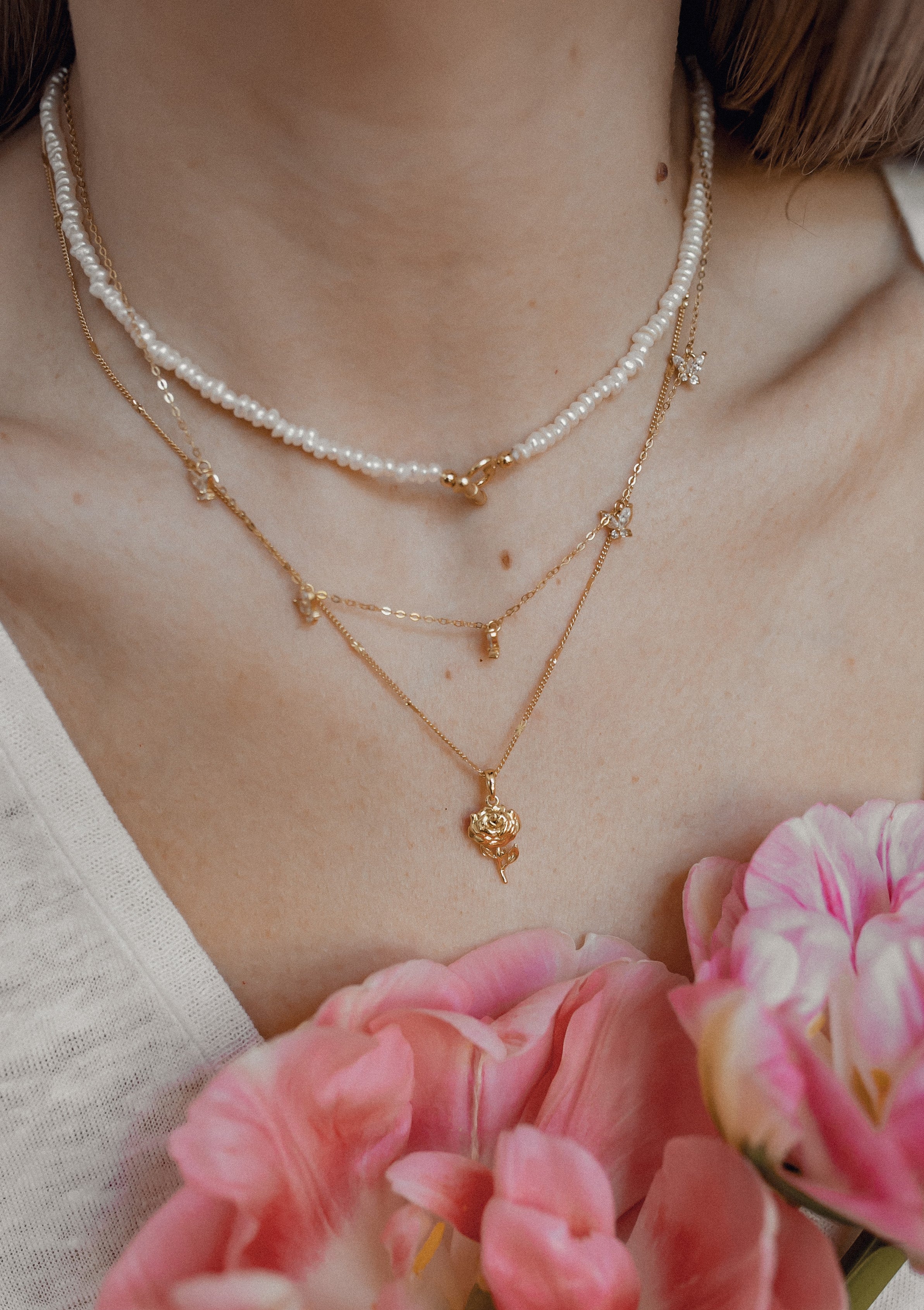 A classic petite pearl choker with popular rose gold crystals at center echoed by rose gold color spacer beads and rose gold toggle clasp